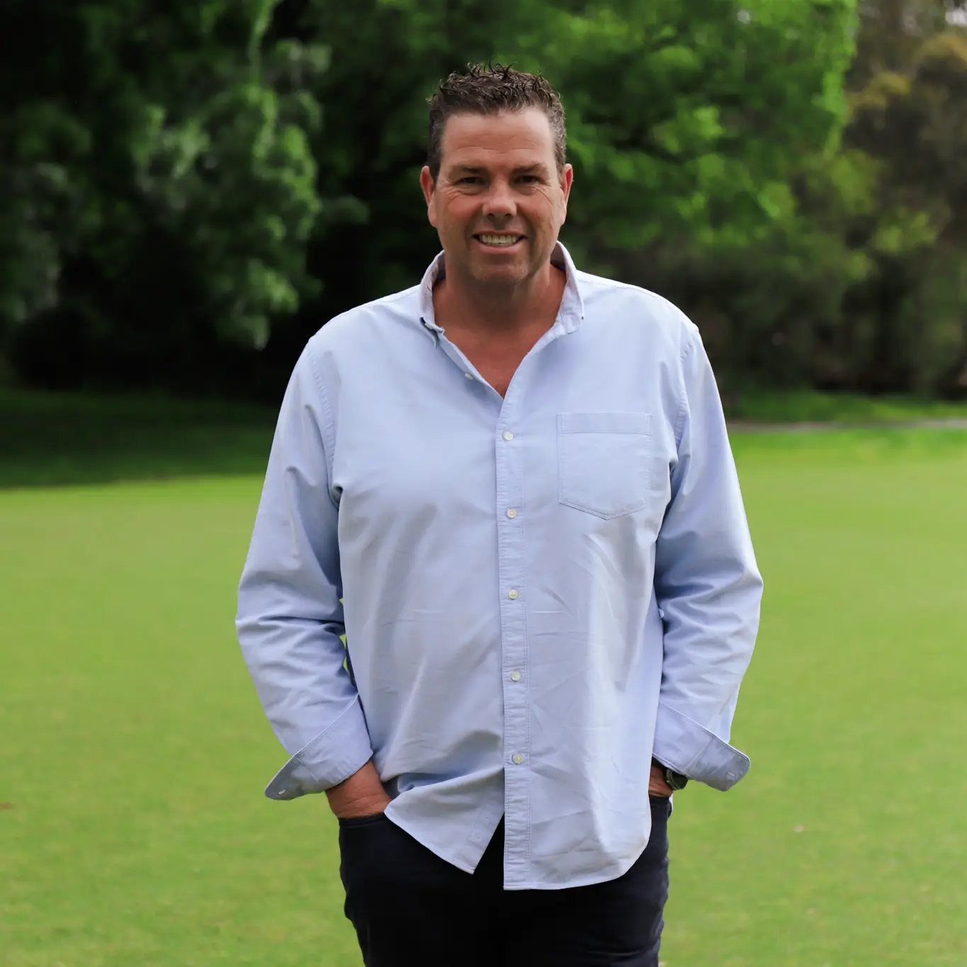 Paul Connors with hands in pockets smiling